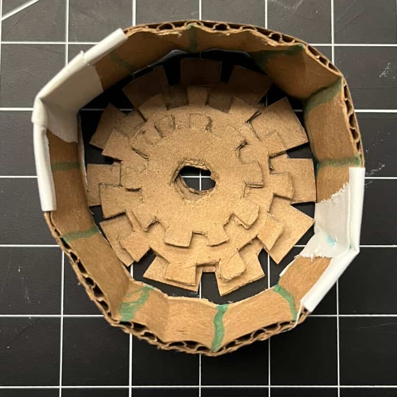Placing the assembled gears into the container to test if the idea can be implemented in our project prototype.